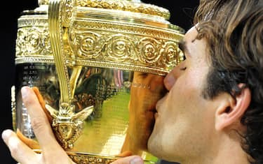 File photo dated 08-07-2012 of Roger Federer kissing the Wimbledon Trophy. Roger Federer has announced he will retire from professional tennis after the Laver Cup. Issue date: Thursday September 15, 2022.