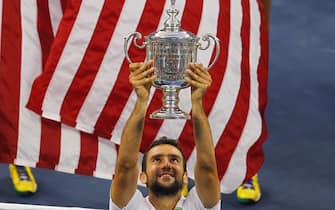 Marin Cilic of Croatia holds the trophy after defeating Kei Nishikori of Japan in the men's final at the US Open tennis championship in New York, September 8, 2014. (Photo by Gary Hershorn/Corbis via Getty Images)