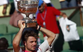PARIS, FRANCE - JUNE 07: Stanislas Wawrinka of Switzerland poses with the Coupe de Mousquetaires after victory in the Men's Singles Final against Novak Djokovic of Serbia on day fifteen of the 2015 French Open at Roland Garros on June 7, 2015 in Paris, France. (Photo by Antoine Gyori/Corbis via Getty Images)