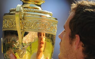 Andy Murray of Great Britain's reflection in the trophy after winning the 2013 Wimbledon Men's Singles Final against Novak Djokovic of Serbia on day thirteen of the 2013 Wimbledon Tennis Championships at the All England Lawn Tennis and Croquet Club in London, United Kingdom. Photo: Visionhaus/Ben Radford (Photo by Ben Radford/Corbis via Getty Images)