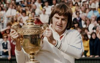 Jimmy Connors of the United States holds the trophy at winning the Men's Singles Final match against Ken Rosewall at the Wimbledon Lawn Tennis Championship on 6 July 1974 at the All England Lawn Tennis and Croquet Club in Wimbledon in London, England. (Photo by Keystone/Getty Images)