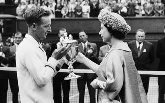 Queen Elizabeth of England presents the 1962 Wimbledon trophy to Rod Laver of Australia.