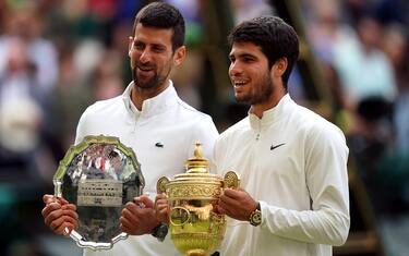 Carlos Alcaraz with the Gentlemen's Singles Trophy, alongside Novak Djokovic with the runners up plate/trophy following Gentlemen's Singles final on day fourteen of the 2023 Wimbledon Championships at the All England Lawn Tennis and Croquet Club in Wimbledon. Picture date: Sunday July 16, 2023.