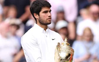 Carlos Alcaraz with the Gentlemen's Singles Trophy following his victory over Novak Djokovic on day fourteen of the 2023 Wimbledon Championships at the All England Lawn Tennis and Croquet Club in Wimbledon. Picture date: Sunday July 16, 2023.