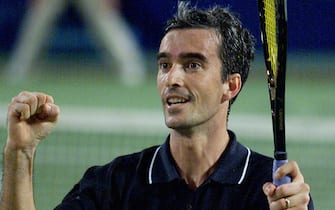 PER19 - 20020102 - PERTH, AUSTRALIA : Italy's Davide Sanguinetti celebrates after winning over Jan-Michael Gambill of the USA at the Hopman Cup mixed teams' tennis event at the Burswood Dome in Perth, 02 January 2002. Sanguinetti won in straight sets 7-6 (7/1), 6-3, to give his country a two rubbers to nil lead in the tie, after Francesca Schiavone defeated Monica Seles in a hard fought three set match 6-4, 2-6, 6-4.   
EPA PHOTO AFPI/GREG WOOD