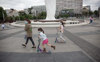 MADRID, SPAIN - APRIL 26. Mother walking with her daughters on April 26, 2020,​ at Plaza de Colón in Madrid, Spain. Children in Spain, which has had one of the stricter lockdowns in Europe, are now allowed to leave their homes for up to an hour per day. The country has had more than 220,000 confirmed cases of COVID-19 and over 20,000 reported deaths, although the rate has declined after weeks of quarantine measures. (Photo by Miguel Pereira/Getty Images).