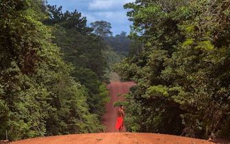 A Waiapi man walks on the road in the Waiapi indigenous reserve in Amapa state in Brazil on October 15, 2017. 
Tribal chieftain Tzako Waiapi perfectly remembers the day almost half a century ago when his hunting party stumbled across a group of white adventurers in the Amazon rainforest. Within months, nearly everyone in his entire tribe had died from disease.  / AFP PHOTO / Apu Gomes / TO GO WITH AFP STORY "When the Waipai tribe almost died out" by Sebastian Smith        (Photo credit should read APU GOMES/AFP via Getty Images)