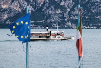 BRENZONE, ITALY - AUGUST 15:  A damaged European flag is seen alongside an Italian flag wrapped around a pole as a ferry passes on Lake Garda on August 15, 2019 in Brenzone, Italy. (Photo by Michel Porro/Getty Images)