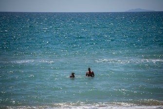 TERRACINA, ITALY - MAY 07: People swim in the empty sea about 100 km (80 miles) south of Rome during the fourth day of the so called phase two due to the Coronavirus (Covid-19) pandemic, on May 7, 2020 in Terracina, Italy. Italy was the first country to impose a nationwide lockdown to stem the transmission of the Coronavirus (Covid-19), and its restaurants, theaters and many other businesses remain closed. (Photo by Antonio Masiello/Getty Images)
