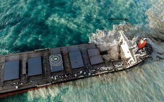 An aerial view taken on August 15, 2020 shows the vessel MV Wakashio, belonging to a Japanese company but Panamanian-flagged that had run aground near Blue Bay Marine Park, Mauritius three weeks ago. - A fresh streak of oil spilled on August 14, 2020, from a ship stranded on a reef in pristine waters off Mauritius, threatening further ecological devastation as demands mount for answers as to why the vessel had come so close to shore. (Photo by STRINGER / AFP) / The erroneous mention[s] appearing in the metadata of this photo by STRINGER has been modified in AFP systems in the following manner: Source IPTC should read [AFP] instead of [L'Express Maurice]. Please immediately remove the erroneous mention[s] from all your online services and delete it (them) from your servers. If you have been authorized by AFP to distribute it (them) to third parties, please ensure that the same actions are carried out by them. Failure to promptly comply with these instructions will entail liability on your part for any continued or post notification usage. Therefore we thank you very much for all your attention and prompt action. We are sorry for the inconvenience this notification may cause and remain at your disposal for any further information you may require. (Photo by STRINGER/AFP via Getty Images)
