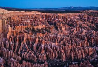 1070799226 BRYCE CANYON NATIONAL PARK, UT - NOVEMBER 8: The unusual sandstone rock formations in Bryce Canyon Amphitheater are viewed before sunrise on November 8, 2018 in Bryce Canyon National Park, Utah. Bryce Canyon National Park, located 2 hours north of Zion National Park, features spectacular geologic formations including mountains, canyons, spires known as hoodoos, buttes, mesas, monoliths, rivers, and natural arches. (Photo by George Rose/Getty Images)