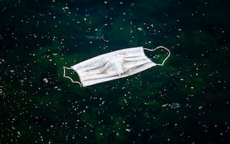 A discarded face mask floats in the Bosphorus Strait on May 10, 2020, at Kabatas in Istanbul, after a month and a half of lockdown restrictions aimed at stemming the spread of the novel coronavirus, COVID-19. - Turkish people aged 65 and over on May 10, 2020, described their joy after the government allowed them to go outside for the first time in nearly two months in an easing of the coronavirus restrictions. While 24 provinces including Ankara and Istanbul are subject to a weekend lockdown, President Recep Tayyip Erdogan said last week senior citizens could leave their homes between 0800 GMT and 1200 GMT on May 10. (Photo by Ozan KOSE / AFP) (Photo by OZAN KOSE/AFP via Getty Images)