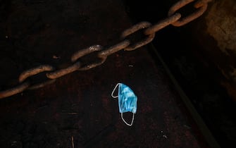 A facemask lies on the ground at the Yangon jetty on May 27, 2020. (Photo by Ye Aung THU / AFP) (Photo by YE AUNG THU/AFP via Getty Images)