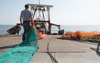 LEIGH ON SEA, ENGLAND - APRIL 24: Two fishermen prepare their boat "Lilley - G" to head out to fish for Dover Sole on April 24, 2020 in Leigh on Sea, England. The UK fishing sector has been badly affected by the coronavirus crisis, with restaurants closed demand for catch has fallen along with suppliers struggling to ship abroad. The British government has extended the lockdown restrictions first introduced on March 23 that are meant to slow the spread of COVID-19. (Photo by John Keeble/Getty Images)