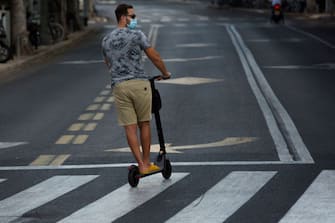TEL AVIV, ISRAEL - SEPTEMBER 18:  Israeli man rides a motor scooter at an empty road as Israel enters a new lockdown on  September 18, 2020 in Tel Aviv, Israel. As the country grapples with a surge in Covid-19 cases it has imposed a three-week lockdown that coincides with Rosh Hashanah, the Jewish new year, and Yom Kippur, the Day of Atonement.  (Photo by Amir Levy/Getty Images)