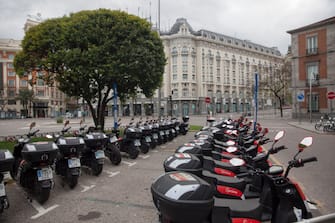 MADRID, SPAIN - APRIL 26. Bike-sharing motorcycles lined up unused in front of the Palace Hotel (closed) on April 26, 2020, in Madrid, Spain. Children in Spain, which has had one of the stricter lockdowns in Europe, are now allowed to leave their homes for up to an hour per day. The country has had more than 220,000 confirmed cases of COVID-19 and over 20,000 reported deaths, although the rate has declined after weeks of quarantine measures. (Photo by Miguel Pereira/Getty Images)