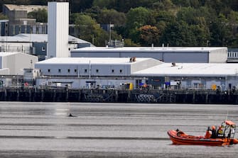 GARELOCHEAD, SCOTLAND - OCTOBER 01: One of the three Northern Bottlenose whales is seen in the Gare Loch as boats try to herd them into the open sea ahead of a military exercise starting in the region on October 1, 2020 in Garelochhead, Argyll and Bute.Three northern bottlenose whales have been stuck in Gare Loch near Faslane Naval Base, apparently unable to find their way back to the North Atlantic. (Photo by Jeff J Mitchell/Getty Images)