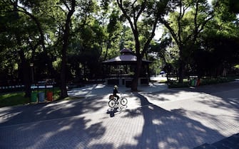 A woman rides a bicycle at the Chapultepec Forest in Mexico City on March 24, 2020. - Mexico's  undersecretary of health prevention and promotion, Hugo Lopez-Gatell Ramirez, said the country was entering "phase two" of its coronavirus approach, moving from containment to "mitigation." The decision came after Mexico's confirmed cases rose to 367, five percent of which have come from domestic transmission. (Photo by RODRIGO ARANGUA / AFP) (Photo by RODRIGO ARANGUA/AFP via Getty Images)