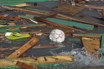 LIVORNO, ITALY - SEPTEMBER 26:  A soccer ball in the wood and plastic debris in the sea that people tried to collect voluntarily because of their love for the environment after a storm on September 26, 2020 in Livorno, Italy. People collected debris after the Tuscan coast was hit the previous evening by a storm before the institutions intervened and stopped them due to safety reasons.  (Photo by Laura Lezza/Getty Images)