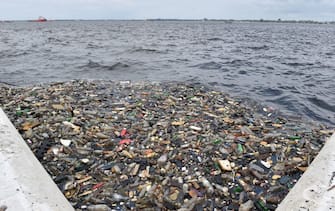 Plastic bottles and other waste float in the water near the port of Abidjan on August 5, 2015 despite efforts by the government to promote a greener economy by banning plastic bags. AFP PHOTO / ISSOUF SANOGO / AFP PHOTO / Issouf SANOGO        (Photo credit should read ISSOUF SANOGO/AFP via Getty Images)