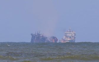 SRI LANKA TRANSPORT DISASTER SHIP FIRE epa09242440 A ship from the Dutch salvage company SMIT (R) towing the fire gutted and crippled container cargo vessel MV X-Press Pearl to deeper seas off the port of Colombo, Sri Lanka, 02 June 2021. The fire on the Singaporean flagged container cargo vessel MV X-Press Pearl, which had been burning for over 13 days, was doused and the salvage company began towing it towards deeper seas off the coast of Colombo on 02 June. However, latest reports by the Sri Lanka Navy stated that the towing operation had been halted as the stern of the ship was striking the seabed. They also reported that so far no oil spills have been observed. A huge amount of plastic granules and debris has already washed ashore on beaches from Colombo to Negombo and authorities now fear another wave of massive pollution should the 278 tonnes of bunker oil and 50 tonnes of gas in the Singapore-registered ship's fuel tanks leak into the Indian Ocean. EPA/CHAMILA KARUNARATHNE
