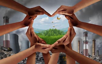 Earthday and earth day as group of diverse people joining to form heart hands together protecting the environment from toxic pollution promoting.