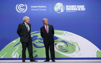 epa09557168 British Prime Minister Boris Johnson (L) and United Nations (UN) Secretary General Antonio Guterres (R) await for the leaders to arrive to attend the climate change conference COP26 in Glasgow, Britain 01 November 2021. The 2021 United Nations Climate Change Conference (COP26) runs from 31 October to 12 November 2021 in Glasgow.  EPA/ROBERT PERRY
