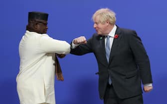 epa09557188 British Prime Minister Boris Johnson (R) greets Sierra Leone's President Julius Maada Bio (L) as leaders arrive to attend the COP26 UN Climate Change Conference in Glasgow, Britain 01 November 2021. The 2021 United Nations Climate Change Conference (COP26) runs from 31 October to 12 November 2021 in Glasgow.  EPA/ROBERT PERRY