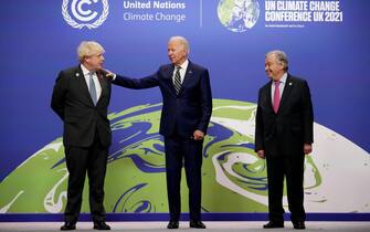 Britain's Prime Minister Boris Johnson (L) and United Nations (UN) Secretary General Antonio Guterres pose with US President Joe Biden as he arrives to attend the COP26 UN Climate Change Conference in Glasgow, Scotland on November 1, 2021. - COP26, running from October 31 to November 12 in Glasgow will be the biggest climate conference since the 2015 Paris summit and is seen as crucial in setting worldwide emission targets to slow global warming, as well as firming up other key commitments. (Photo by Christopher Furlong / POOL / AFP) (Photo by CHRISTOPHER FURLONG/POOL/AFP via Getty Images)