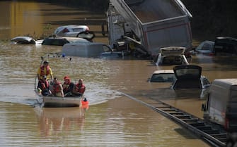 A rescue boat patrols next to submerged cars and other vehicles on a flooded section of the federal highway B265 in Erftstadt, western Germany, on July 17, 2021, following heavy rains and floods. (Photo by SEBASTIEN BOZON / AFP) (Photo by SEBASTIEN BOZON/AFP via Getty Images)