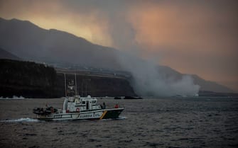 LA PALMA, SPAIN - SEPTEMBER 29: A boat sails past as lava flows from the Cumbre Vieja volcano towards the Atlantic Ocean on September 29, 2021 in in La Palma, Canary Islands, Spain. Lava continues to flow in the aftermath of the island's first volcanic eruption in 20 years, destroying hundreds of property and forcing the evacuation of over 6,000 people. (Photo by Kike Rincon/Europa Press via Getty Images)