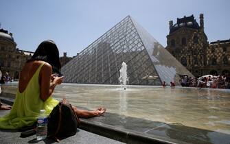 TOPSHOT - A sunbather sits near a fountain in front of The Louvre Pyramid in Paris on June 17, 2022, as a heatwave sweeps across much of France and Europe. - French officials have urged caution as a record pre-summer heatwave spread across the country from Spain, where authorities were fighting forest fires on a sixth day of sweltering temperatures. The Meteo France weather service said it was the earliest hot spell ever to hit the country, worsening a drought caused by an unusually dry winter and spring, and raising the risk of wildfires.
 - RESTRICTED TO EDITORIAL USE - MANDATORY MENTION OF THE ARTIST Ieoh Ming Pei (I.M. PEI) UPON PUBLICATION - TO ILLUSTRATE THE EVENT AS SPECIFIED IN THE CAPTION (Photo by Stefano RELLANDINI / AFP) / RESTRICTED TO EDITORIAL USE - MANDATORY MENTION OF THE ARTIST Ieoh Ming Pei (I.M. PEI) UPON PUBLICATION - TO ILLUSTRATE THE EVENT AS SPECIFIED IN THE CAPTION / RESTRICTED TO EDITORIAL USE - MANDATORY MENTION OF THE ARTIST Ieoh Ming Pei (I.M. PEI) UPON PUBLICATION - TO ILLUSTRATE THE EVENT AS SPECIFIED IN THE CAPTION (Photo by STEFANO RELLANDINI/AFP via Getty Images)
