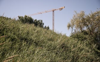 SALERNO, ITALY - JUNE 19: A construction crane is seen in a rural area near the city on June 19, 2022 in Salerno, Italy. In Italy, the latest ISPRA report published in July 2021, denounces the continuous loss of soil in a country that has various emergencies including: hydrogeological risks, desertification risk, loss of water resources, increase in average temperatures in cities due to continuous overbuilding. (Photo by Ivan Romano/Getty Images)