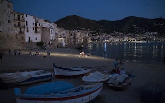 CEFALU, ITALY - JULY 10: Boats are seen at night in the old port during summer season as local and foreigner tourists start to gather in Cefalu, the old town in Palermoâs province (Sicily), included in the UNESCOâs heritage list for its Arab-Norman architecture, Italy on July 10, 2022. The wide coastline, with sandy and rocky beaches, also attracts tourists. (Photo by Valeria Ferraro/Anadolu Agency via Getty Images)