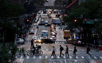 NEW YORK, NY - JUNE 6: People walk across 42nd Steet as the sun sets on June 6, 2022, in New York City. (Photo by Gary Hershorn/Getty Images)