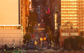 1399834484 WEEHAWKEN, NJ - MAY 28: Traffic moves along 42nd Street as the sun sets in New York City on May 28, 2022, as seen from Weehawken, New Jersey. (Photo by Gary Hershorn/Getty Images)