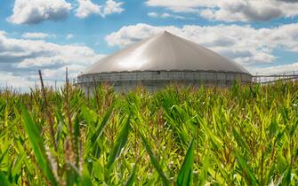 Wide angle shot of a modern biogas plant under a great cloudscape.