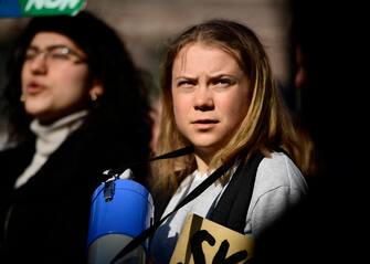 epa09848732 Swedish climate activist Greta Thunberg (C) along with other activists and students takes part in a Fridays For Future school strike for climate and social justice in Stockholm, Sweden, 25 March 2022. The 10th global strike of Fridays for Future takes place under the motto '#PeopleNotProfit'.  EPA/PAUL WENNERHOLM SWEDEN OUT