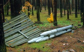 KHARKIV REGION, UKRAINE - OCTOBER 26, 2022 - Three rocket projectiles are pictured in a forest near Izium after the liberation of the area from Russian invaders, Kharkiv Region, northeastern Ukraine.