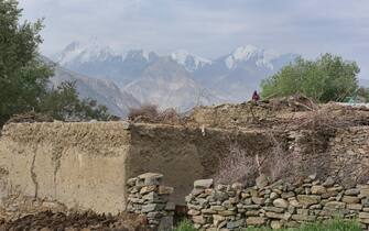 Traditional home in the Wakhan Valley with the Afghanistan Hindu Kush behind, Langar, Tajikistan