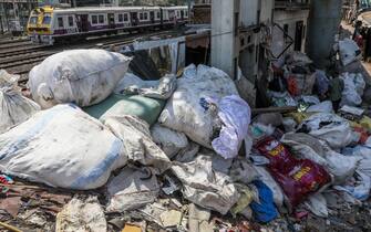 epa10671106 A train passes by the plastic dumped near the tracks at a recycling unit in Dharavi, Mumbai, India, 22 May 2023. (Issued 03 June 2023) According to the report issued Swachh Bharat Mission (Urban) Plastic Waste Management Solutions and Case Studies, government of India, It is estimated that approximately 70% of plastic packaging products are converted into plastic waste in a short span. The world will mark Environment Day on 05 June 2023 and it will focus on solutions to plastic pollution.  EPA/DIVYAKANT SOLANKI  ATTENTION: This Image is part of a PHOTO SET