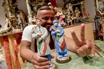 Neapolitan artisan Genny Di Virgilio shows a figurine depicting a Italian doctor and a Italian nurse who will be featured in the traditional Neapolitan Presepio (crib) at San Gregorio Armeno street in Naples, Italy, 08 May 2020. Italy entered the second phase of its coronavirus emergency on 04 May with the start of the gradual relaxation of the lockdown measures that have been in force for 55 days.     ANSA / CIRO FUSCO