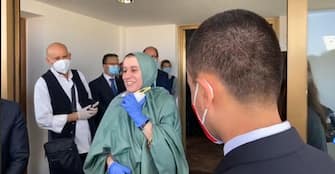 In an image from the Facebook profile of the Italian Esetri minsitro, Luigi Di Maio, Silvia Romano, the cooperant kidnapped in Kenya in November 2018 and released on Friday evening, welcomed on arrival at Ciampino airport, Rome, Italy, May 10 2020. ANSA
+++ ANSA PROVIDES ACCESS TO THIS HANDOUT PHOTO TO BE USED SOLELY TO ILLUSTRATE NEWS REPORTING OR COMMENTARY ON THE FACTS OR EVENTS DEPICTED IN THIS IMAGE; NO ARCHIVING; NO LICENSING +++
