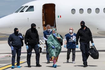 Italian cooperator, Silvia Romano, wearing a green tunic,  upon her arrival at the Ciampino airport, Rome, Italy, 10 May 2020. Silvia Romano was kidnapped on Novembre 2018 in Kenya.. ANSA / FABIO FRUSTACI
