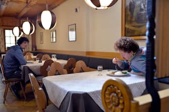 BOLZANO, ITALY - MAY 11: Two men at a restaurant table on May 11, 2020 in Bolzano, Italy. The Bolzano province started the reopening of some businesses one week earlier than the rest of Italy, arising many controversies. (Photo by Alessio Coser/Getty Images)