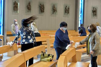 TRENTO, ITALY - MAY 18: A church is sanitizes by the attendees after the celebration of Holy Mass on May 18, 2020 in Trento, Italy. Italy was the first country to impose a nationwide lockdown to stem the transmission of the Coronavirus (Covid-19), the country is now entering in the phase 2 of the lockdown, reopening business activities, museums, theatres and more. (Photo by Alessio Coser/Getty Images)