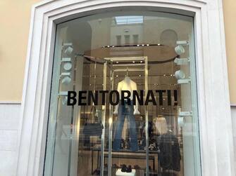 Messaggi di bentornati sulle vetrine dei negozi a Bari nel giorno della riapertura delle attività commerciali, 18 maggio 2020. ANSA