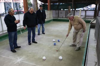 ROME, ITALY - MARCH 06: Seniors play petanque at the bowling alley in the Pigneto districton March 6, 2020 in Rome, Italy.  The average age of Italian patients who have died in relation to Covid-19 is 81 years, they were mostly men (female numbers 28, equal to 26.7%) and in more than two thirds of cases they had three or more pre-existing pathologies. This is what emerges from an analysis of the data of 105 Italian patients, conducted by the Istituto Superiore di SanitÃ , which underlines that there are 20 years of difference between the average age of the deceased and that of coronavirus positive patients . The elderly are now isolated in nursing homes and after the ban on visiting relatives, the residences for the elderly use electronic devices for video calls. The city hall of Rome has decreed the closure of the centers for the elderly to limit the spread of the virus. Sixteen virus-positive seniors were found in a bowling club in the Bologna area. (Photo by Marco Di Lauro/Getty Images)