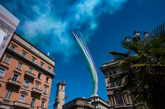 MILAN, ITALY - MAY 25: The Italian national aerobatic team, the Frecce Tricolore, flies over the Piazza Duomo of Milan on May 25, 2020 in Milan, Italy. Restaurants, bars, cafes, hairdressers and other shops have reopened, subject to social distancing measures, after more than two months of a nationwide lockdown meant to curb the spread of Covid-19.
