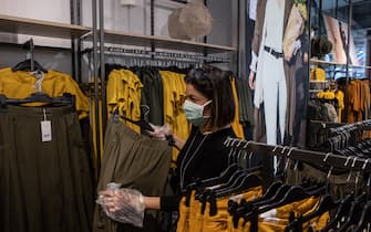 MILAN, ITALY - MAY 18: A customer, wearing a face mask, shops at the Corso Buenos Aires OVS fashion retail store on May 18, 2020 in Milan, Italy. Restaurants, bars, cafes, hairdressers and other shops have reopened, subject to social distancing measures, after more than two months of a nationwide lockdown meant to curb the spread of Covid-19. (Photo by Emanuele Cremaschi/Getty Images)